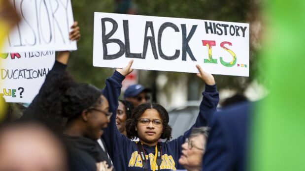 Activists and community members protested Florida’s new education standards, which require middle school students to learn “how slaves developed skills which, in some instances, could be applied for their personal benefit.”